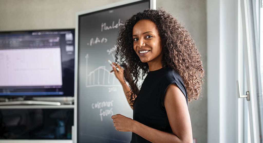 teacher pointing at board