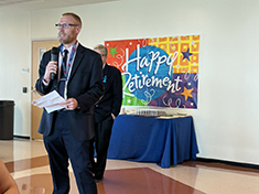 Department Chair, Dr. Ethan Waples, addresing the Marilyn Davies College of Business at the Faculty Retirement Celebration