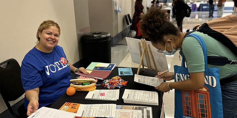 Fall '24 Empowered Youth member signing students up for voting at their SELMA movie event.