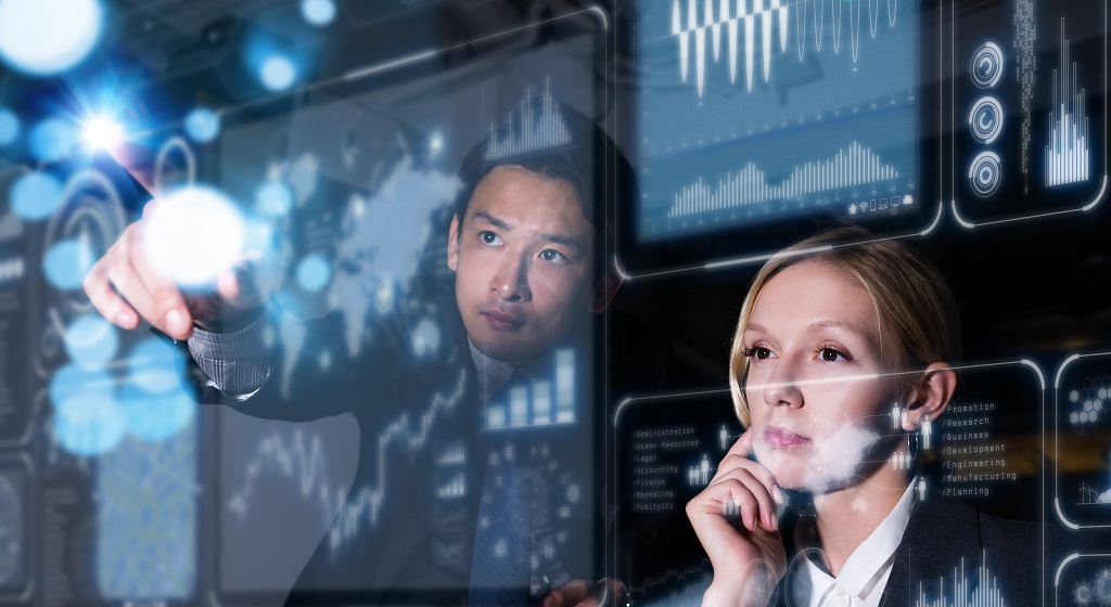 Two people looking at a digital screen.