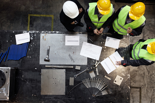 Group of construction workers looking at documents