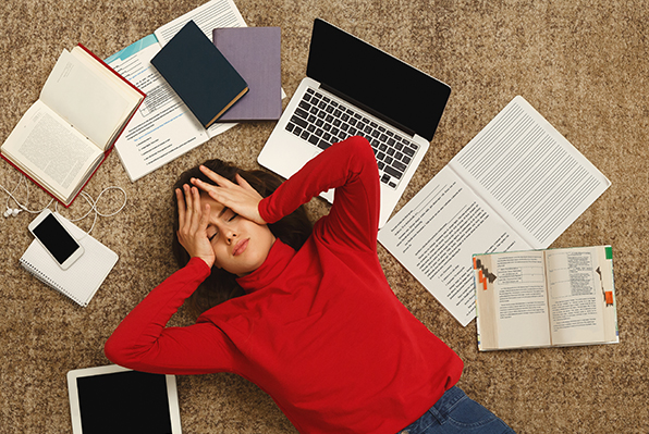 Student lying on floor showing frustration