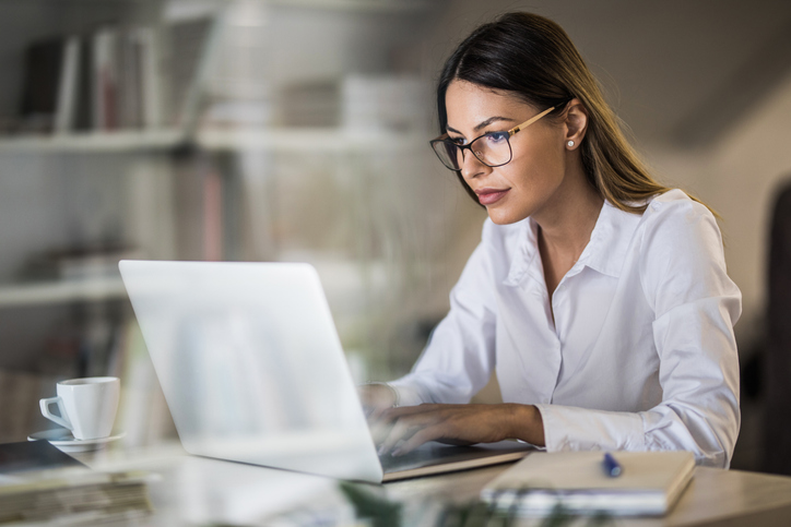 business women sitting at desk with laptop